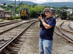 Erik Coleman taking a photo of a train